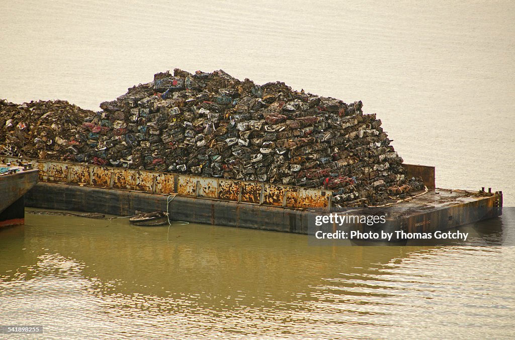 Crushed cars on barge