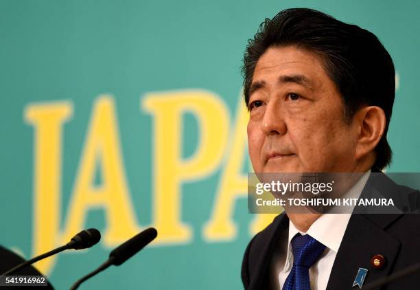 Japanese Prime Minister and ruling Liberal Democratic Party leader Shinzo Abe listens to a question during a debate with eight other party leaders at...