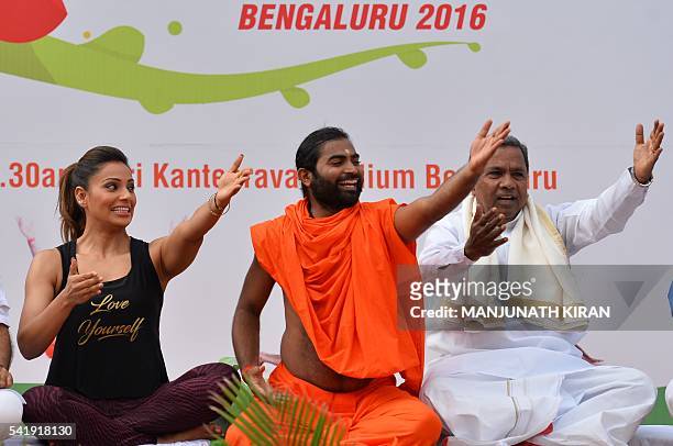 Yoga guru Vachanaananda conducts a laughter session with Chief Minister of Karnataka Siddaramaiah and Bollywood actress Bipasha Basu take part in a...