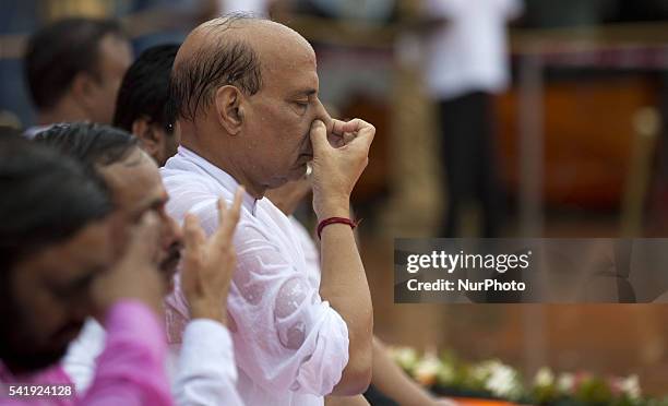 Indian Home Minister mr. Rajnath Singh participates in a mass yoga session , to mark International Yoga Day,during heavy rains at K. D. Singh Babu...