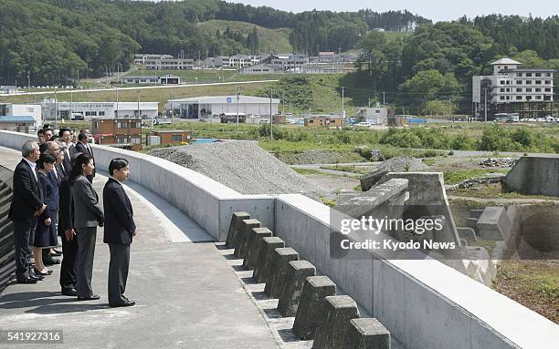 Japan's Crown Prince Naruhito and Crown Princess Masako visit a coastal levee in the northeastern Japan city of Miyako, devastated by the 2011...