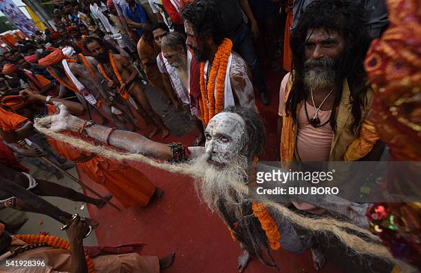 An Indian Hindu sadhu dances in a religious procession on the eve of the annual Ambubachi festival at the Kamakhya temple in Guwahati on June 21,...