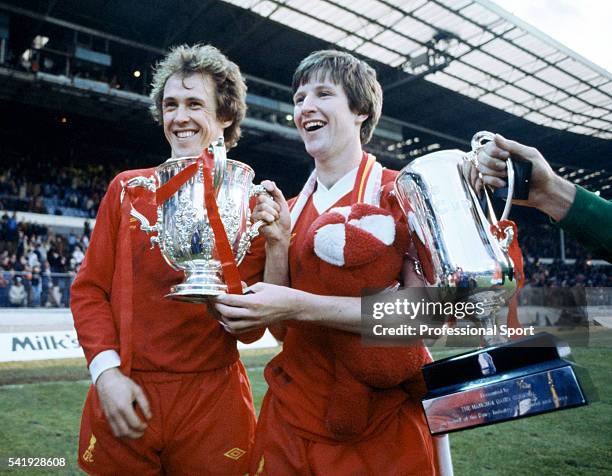 Phil Neal and Ronnie Whelan of Liverpool holding the League Cup following their victory over Tottenham Hotspur in the League Cup Final, sponsored by...