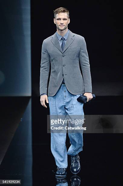 Model walks the runway at the Giorgio Armani Spring Summer 2017 fashion show during Milan Menswear Fashion Week on June 21, 2016 in Milan, Italy.
