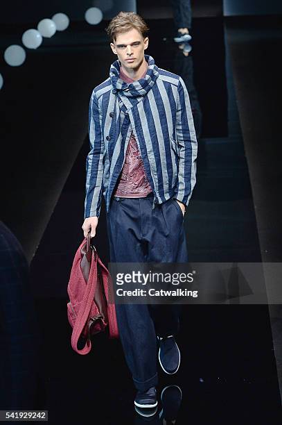 Model walks the runway at the Giorgio Armani Spring Summer 2017 fashion show during Milan Menswear Fashion Week on June 21, 2016 in Milan, Italy.
