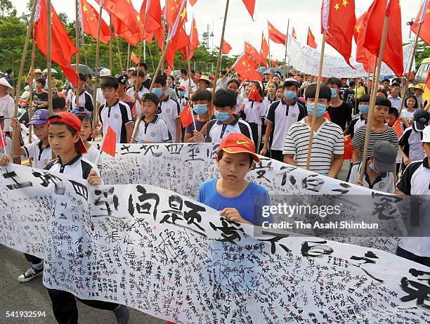 Villagers, including children march on with the national flags demanding return of their leader Lin Zuluan, the Communist Party secretary of the...