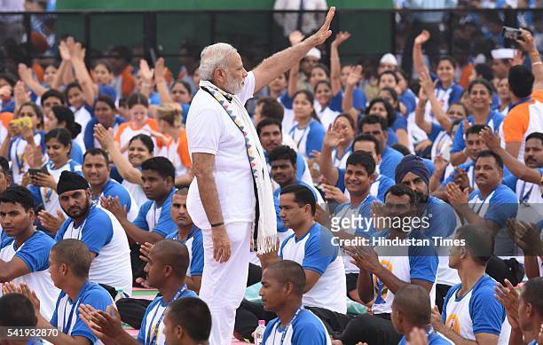 Prime Minister Narendra Modi greets yoga enthusiasts on the 2nd International Yoga Day at Capitol Complex on June 21, 2016 in Chandigarh, India. Modi...
