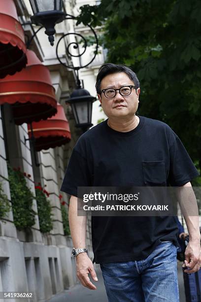 Singapore's director Eric Khoo poses prior to the release of his latest movie 'Hotel Singapura' , on June 21, 2016 in Paris. / AFP / PATRICK KOVARIK