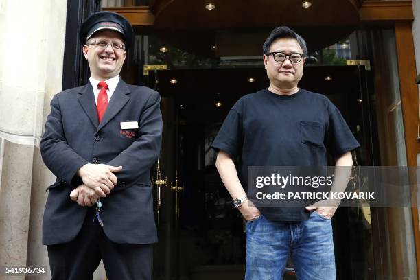 Singapore's director Eric Khoo (R0 poses prior to the release of his latest movie 'Hotel Singapura' , on June 21, 2016 in Paris.