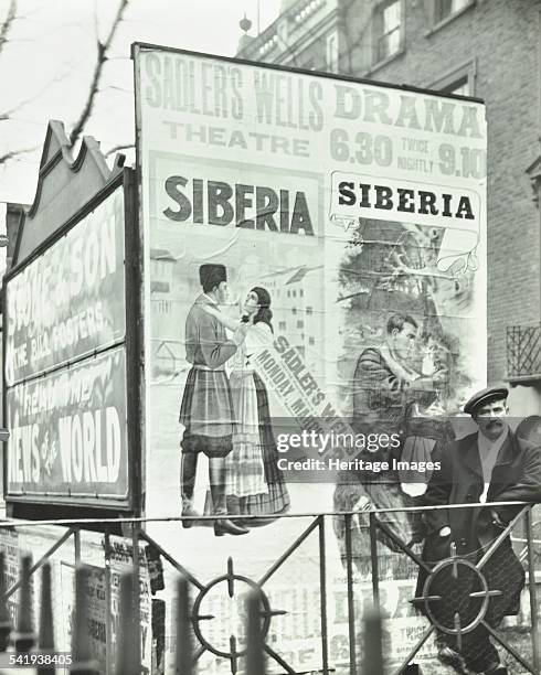 Advertising hoardings, 344 City Road, London, 1911. Large advertisements for Sadler's Wells Theatre and the News of the World on hoardings in front...