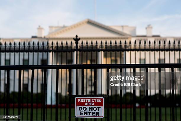 Restricted Area Do Not Enter" sign is on the barricades in front of the White House fence to help deter fence jumpers.
