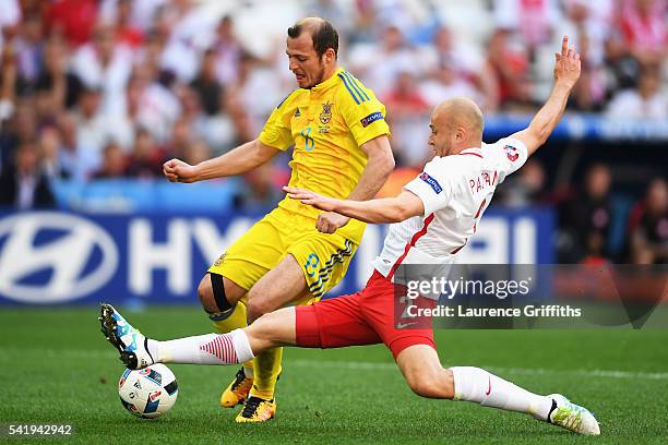 Michal Pazdan of Poland tackles Roman Zozulya of Ukraine during the UEFA EURO 2016 Group C match between Ukraine and Poland at Stade Velodrome on...