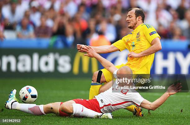 Michal Pazdan of Poland tackles Roman Zozulya of Ukraine during the UEFA EURO 2016 Group C match between Ukraine and Poland at Stade Velodrome on...