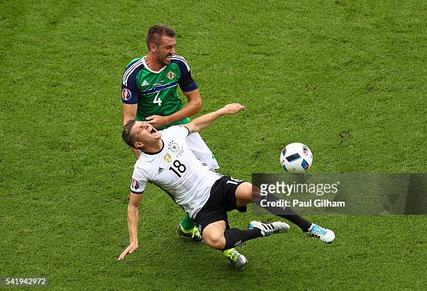 Toni Kroos of Germany is challenged by Gareth McAuley of Northern Ireland during the UEFA EURO 2016 Group C match between Northern Ireland and...
