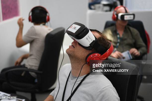 People test out Samsung's Gear VR powered by Oculus during "Sunny Side of the Doc", an international market for documentary films, in La Rochelle on...