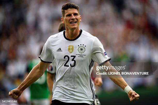 Germany's forward Mario Gomez celebrates scoring the opening goal during the Euro 2016 group C football match between Northern Ireland and Germany at...