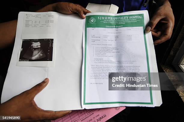Relatives of Sangeeta Devi showing the ultrasound report by SJM Super Specialty Hospital which mentions twins as they stage protest at government...
