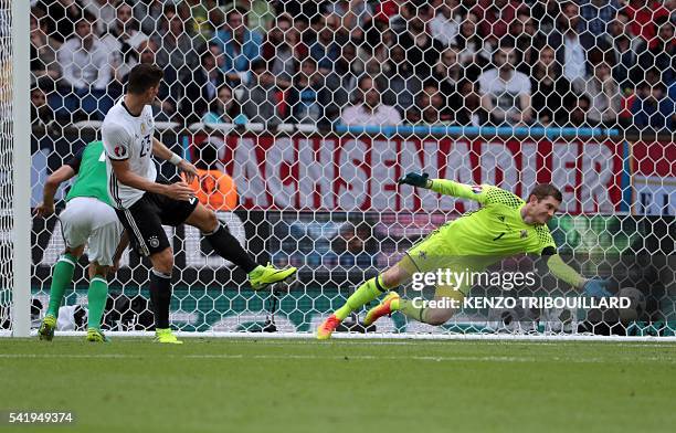 Northern Ireland's goalkeeper Michael McGovern stops a goal attempt by Germany's forward Mario Gomez during the Euro 2016 group C football match...