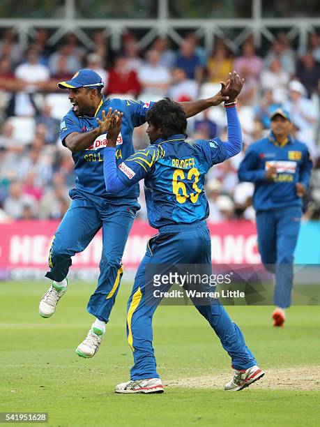 Nuwan Pradeep of Sri Lanka is congratulated by Seekkuge Prasanna after taking the wicket of England Captain, Eoin Morgan during of the 1st ODI Royal...