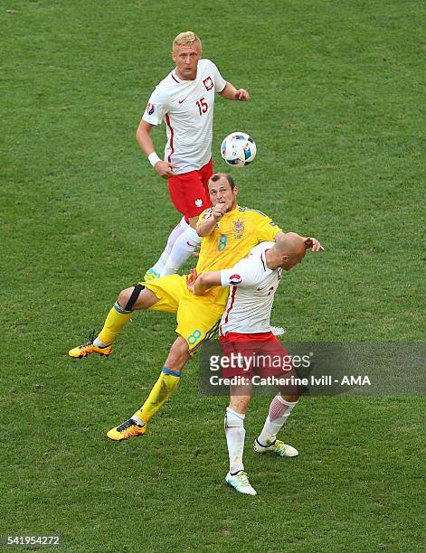 Roman Zozulya of Ukraine in between Kamil Glik and Michal Pazdan of Poland during the UEFA EURO 2016 Group C match between Ukraine and Poland at...