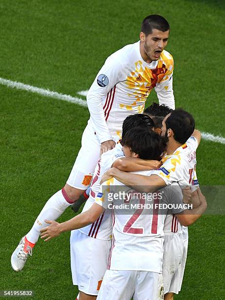 Spain's forward Alvaro Morata celebrates his opening goal with teammates during the Euro 2016 group D football match between Croatia and Spain at the...