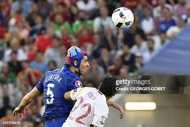 Croatia's defender Vedran Corluka vies for the header with Spain's forward Nolito during the Euro 2016 group D football match between Croatia and...