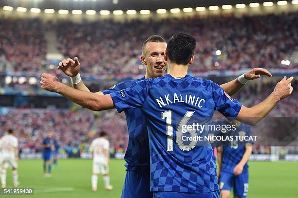 Croatia's forward Nikola Kalinic celebrates with Croatia's midfielder Ivan Perisic after scoring his team's first goal during the Euro 2016 group D...