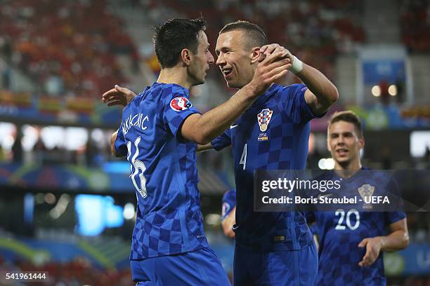 Nikola Kalinic of Croatia celebrates scoring his team's first goal with his team mate Ivan Perisic during the UEFA EURO 2016 Group D match between...