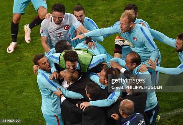 Turkish players celebrate after scoring their second goal during the Euro 2016 group D football match between Czech Republic and Turkey at...