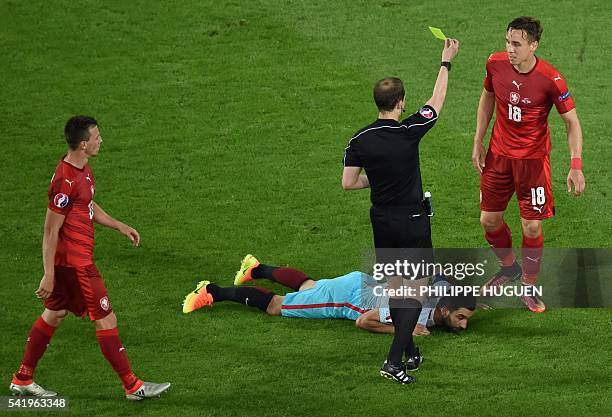 The referee William Collum shows a yellow card to Czech Republic's midfielder Josef Sural during the Euro 2016 group D football match between Czech...