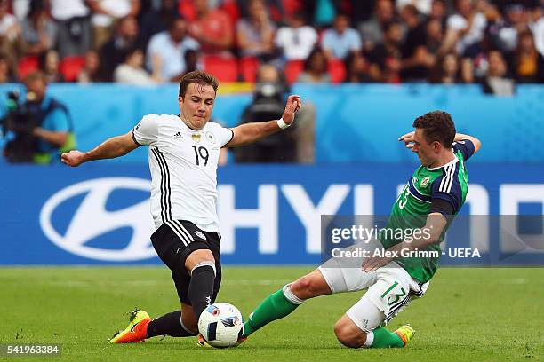 Mario Goetze of Germany competes for the ball with Corry Evans of Northern Ireland during the UEFA EURO 2016 Group C match between Northern Ireland...