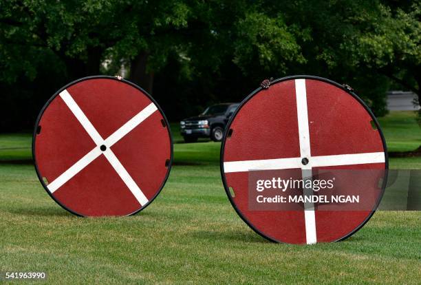 Landing markers are moved for placment on the South Lawn ahead of the return of Marine One and US President Barack Obama to the White House on June...