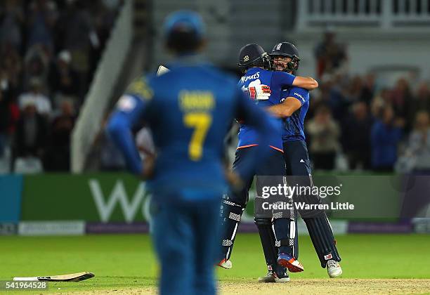 Lian Plunkett of England is congratulated by team mate Chris Woakes after hitting a a six off the last ball the tie the 1st ODI Royal London One Day...