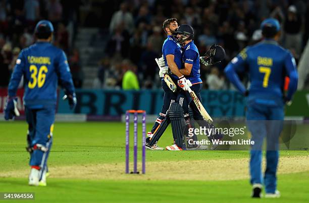 Lian Plunkett of England is congratulated by team mate Chris Woakes after hitting a a six off the last ball the tie the 1st ODI Royal London One Day...