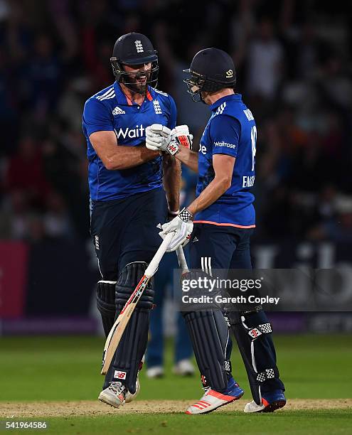 Liam Plunkett of England celebrates with Chris Woakes after hitting six runs from the final ball to tie the 1st ODI Royal London One Day match...