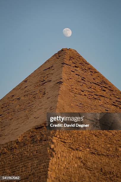 July 28: The moon over the Pyramids of Giza at sunset on July 28, 2015 in Cairo, Egypt. Giza pyramid complex bordering what is now El Giza, Egypt. It...