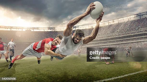 jugador de rugby abordado en mid aire dives de ranura - rugby tournament fotografías e imágenes de stock
