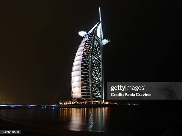 Burj al Arab illuminated at night with white light, Dubai