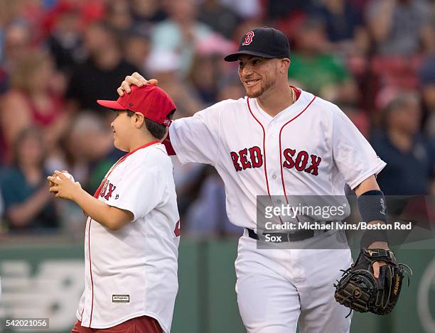 Christian Vazquez of the Boston Red Sox congratulates Special Olympic athlete David Ortiz after he threw out a ceremonial first pitch on June 21, 16...