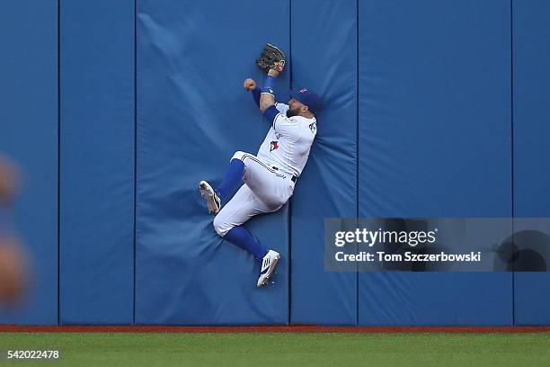 Kevin Pillar of the Toronto Blue Jays catches a fly ball against the wall in the fourth inning during MLB-game action against the Arizona...
