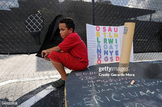 Juan Tatis Zurita pays his respects for the victims of the Pulse Nightclub shooting at the front of the nightclub building on June 21, 2016 in...