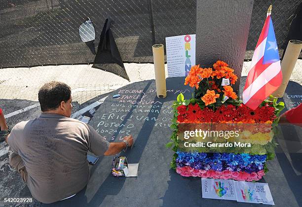 Jose Colon pays his respects for the victims of the Pulse Nightclub shooting at the front of the nightclub building on June 21, 2016 in Orlando,...