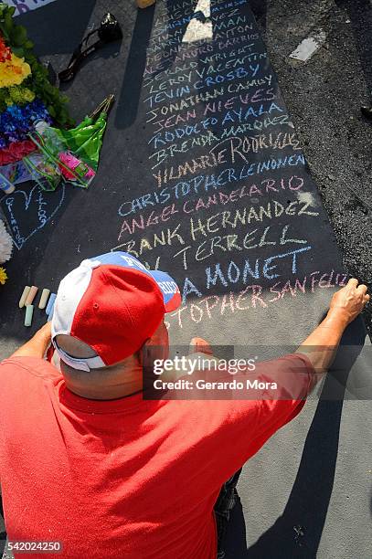Edwin Rodriguez pays his respects for the victims of the Pulse Nightclub shooting at the front of the nightclub building on June 21, 2016 in Orlando,...