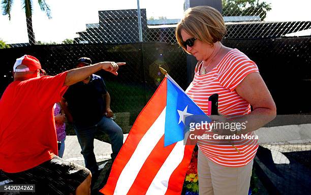 Zoraida Rios pays his respects for the victims of the Pulse Nightclub shooting at the front of the nightclub building on June 21, 2016 in Orlando,...