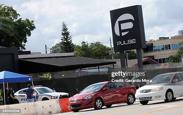 Vehicles cross in front of the Pulse Nightclub on June 21, 2016 in Orlando, Florida. Orlando community continues to mourn deadly mass shooting at gay...