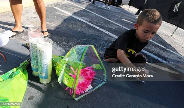Kid writes a message for the victims of the Pulse Nightclub shooting at the front of the nightclub on June 21, 2016 in Orlando, Florida. The Orlando...