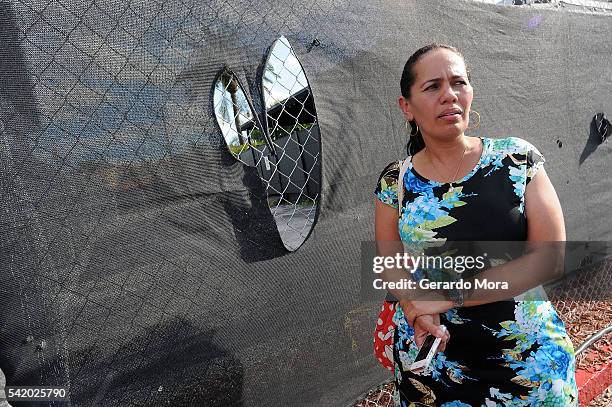 Zila Zurita pays her respects for the victims of the Pulse Nightclub shooting at the front of the nightclub building on June 21, 2016 in Orlando,...