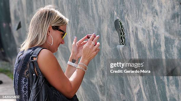 Woman takes pictures at the interior of the Pulse Nightclub building on June 21, 2016 in Orlando, Florida. The Orlando community continues to mourn...