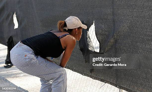 Woman looks through a fence at the site of the Pulse Nightclub building on June 21, 2016 in Orlando, Florida. The Orlando community continues to...