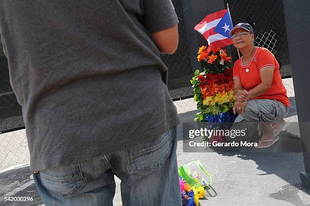 Woman pays her respects for the victims of the Pulse Nightclub shooting at the front of the nightclub building on June 21, 2016 in Orlando, Florida....